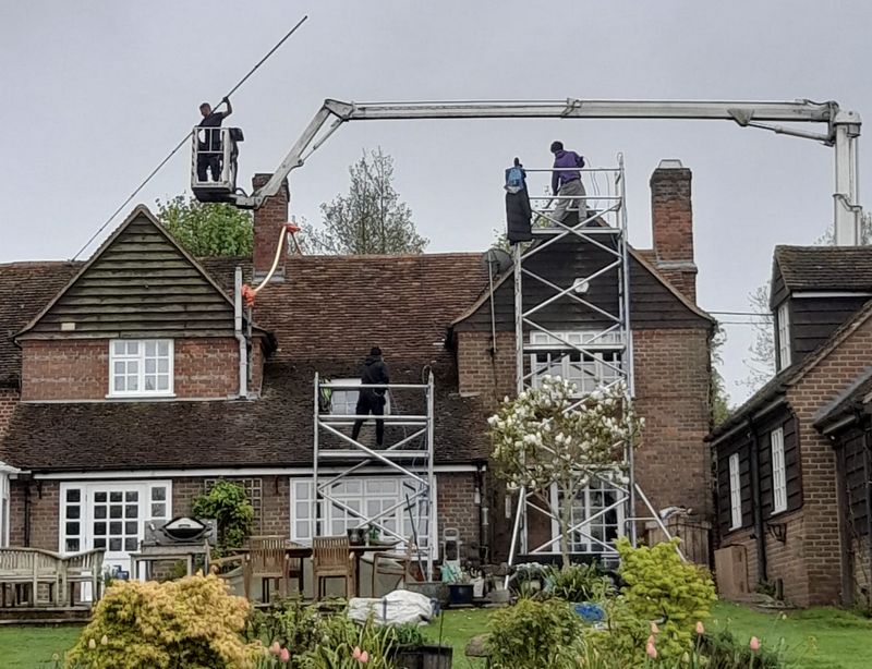 The Roof Moss Cleaners using cherry picker and scaffolding to clean roof safely and professionally in Bishop's Cleeve, Gloucestershire