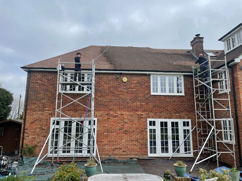 Roof cleaning carried out safely from scaffold towers by The Roof Moss Cleaners in Bishop's Cleeve